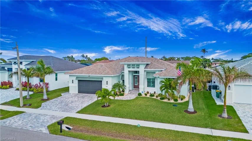 View of front facade with a garage and a front lawn