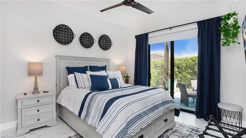 Bedroom featuring ceiling fan and access to exterior
