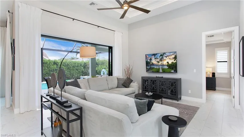 Living room featuring ceiling fan and crown molding