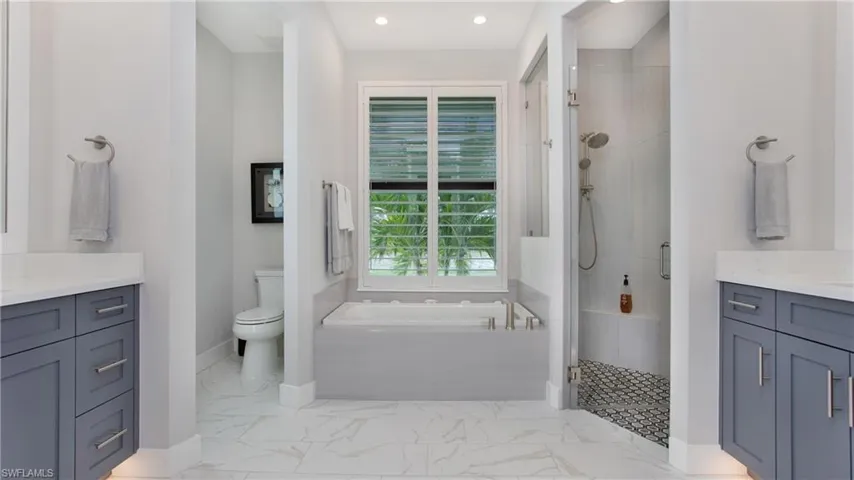 Full bathroom with vanity, toilet, and plus walk in shower