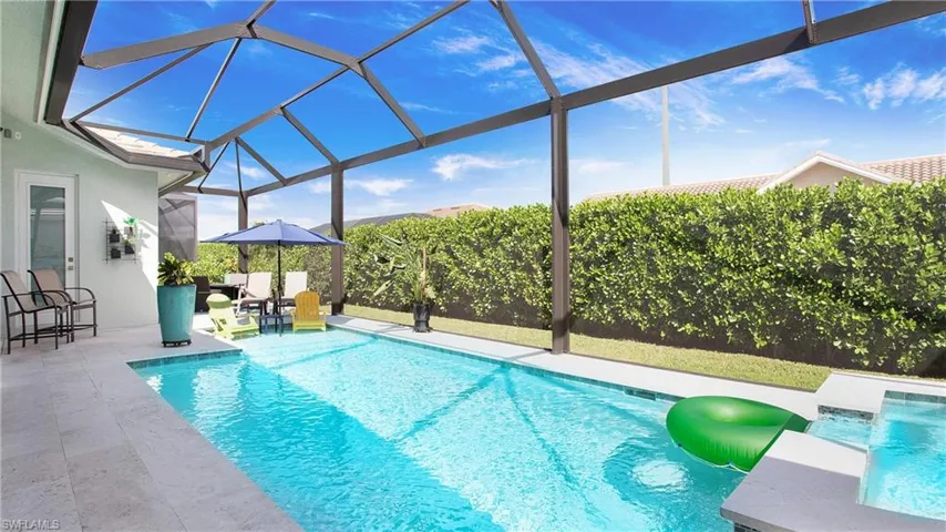 View of swimming pool with a patio area and a lanai
