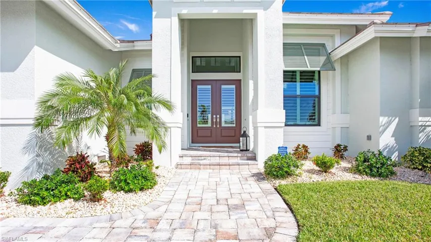 Property entrance featuring french doors