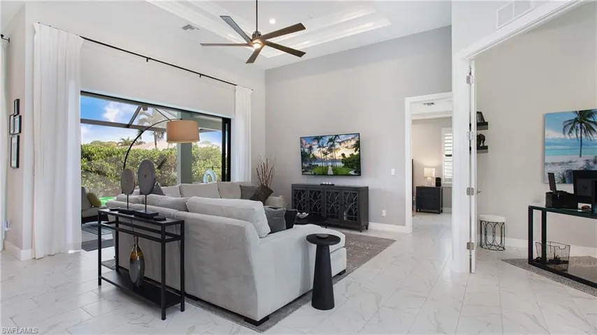 Living room featuring ceiling fan and crown molding