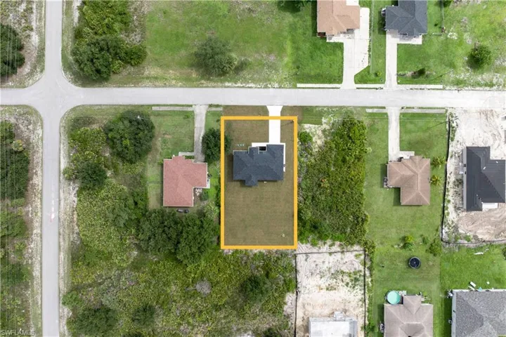 Aerial view of property's location featuring nearby suburban area and property parcel outlined