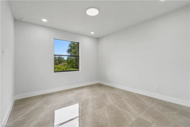 Spare room featuring baseboards and recessed lighting
