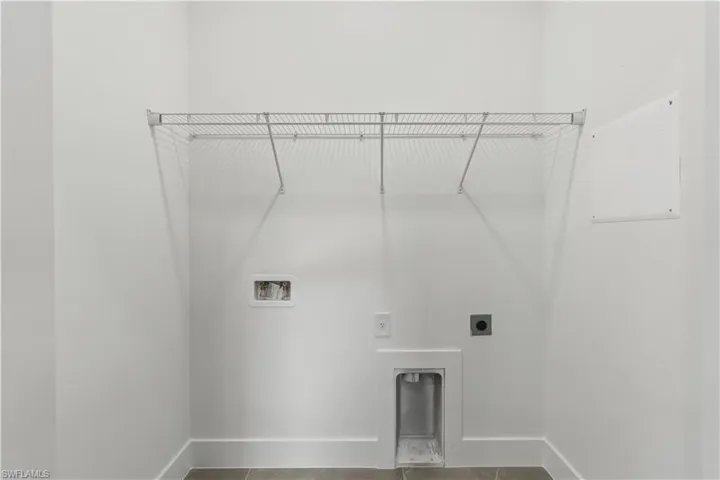 Washroom featuring hookup for an electric dryer, washer hookup, and tile patterned floors