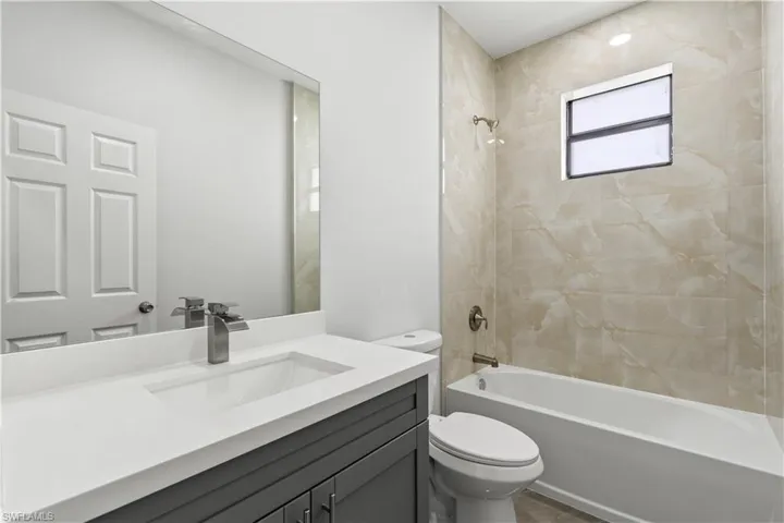 Bathroom featuring shower / washtub combination and vanity