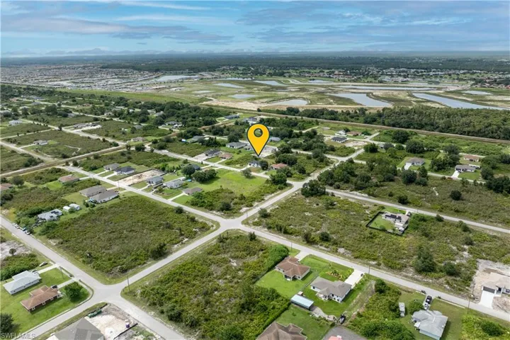 View of property location featuring a large body of water and nearby suburban area