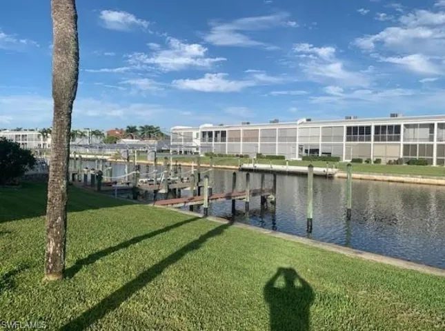 Dock with a lawn, a water view, and boat lift
