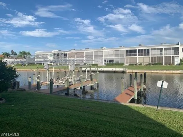 Dock with a water view, a yard, and boat lift