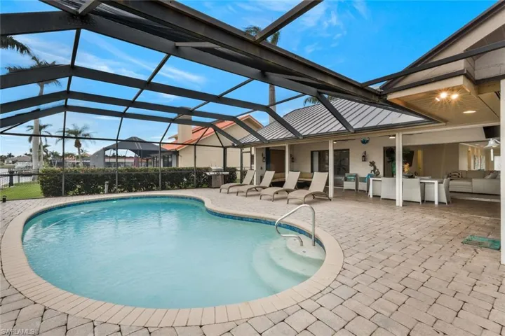 View of pool featuring outdoor lounge area, a patio, and a lanai