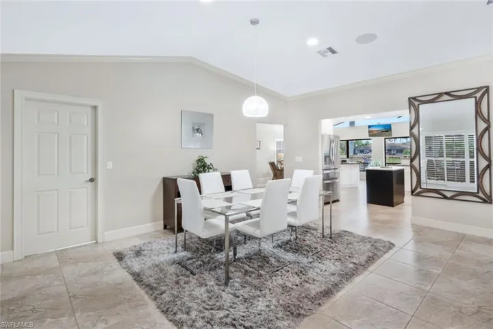 Dining area with crown molding and vaulted ceiling