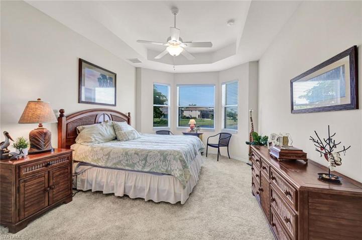 MASTER BEDROOM WITH LAKE VIEWS FROM ALL WINDOWS