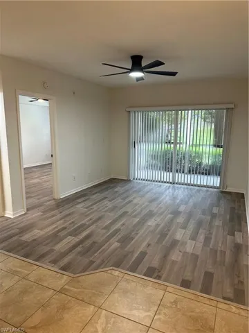 Spare room with wood-type flooring and ceiling fan