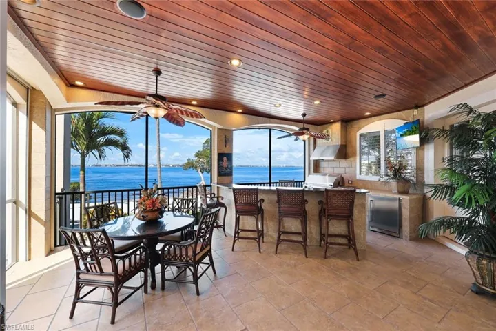 Screen Lanai, hurricane shutter, clear vinyl shades featuring a water view , alfresco Grille, Wet Bar, Granite Countertops steps to your private beach