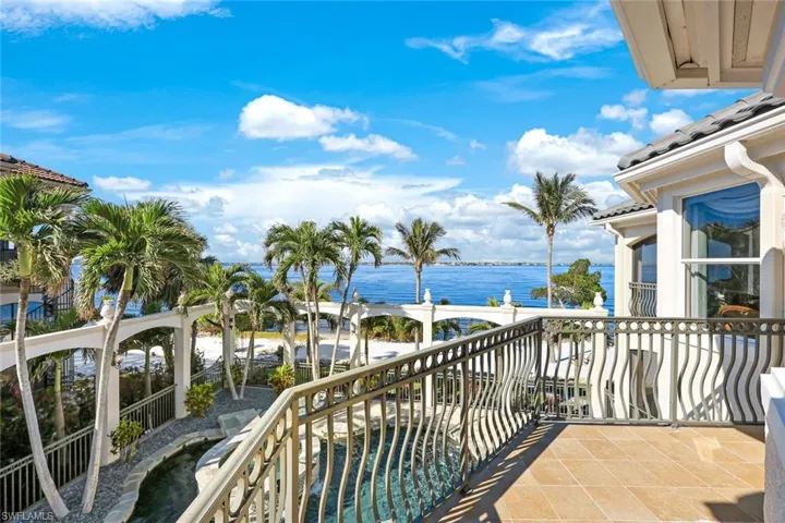 Balcony featuring a water view of the river, spa and lagoon style pool