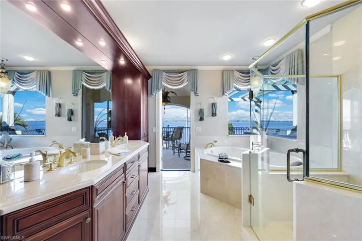 Bathroom featuring vanity, a healthy amount of sunlight, ornamental molding, and separate shower and tub, separate water closet with a toilet and a bidet.