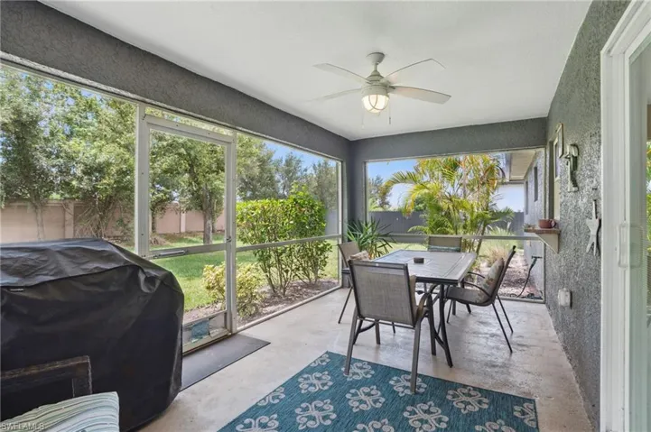 Sunroom / solarium featuring ceiling fan and outdoor dining space