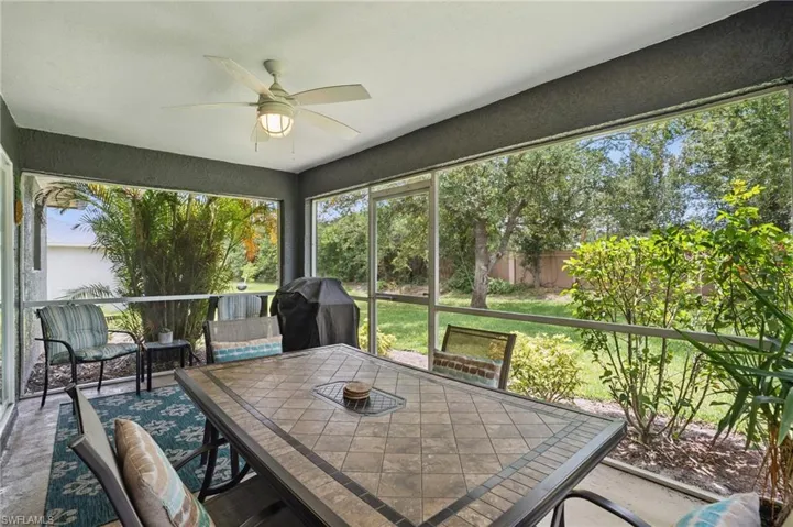 Sunroom with ceiling fan and outdoor dining area