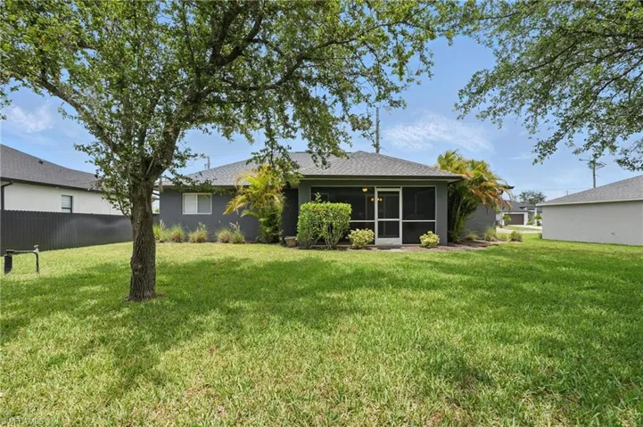 Rear view of property with a sunroom