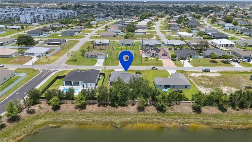 Aerial view of residential area featuring a large body of water