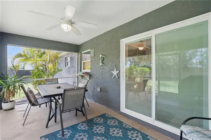 Sunroom with a ceiling fan, outdoor dining area, and plenty of natural light