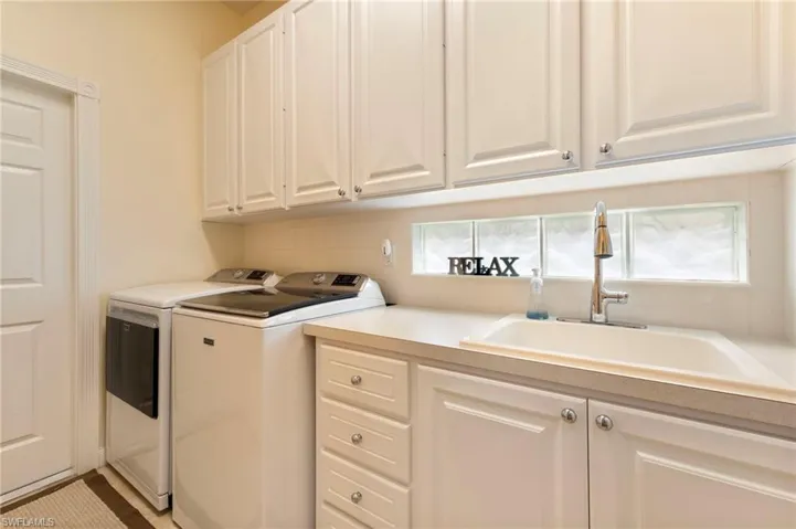 28100 Cetation Way Bonita Springs fL 34135 - Laundry room with utility sink and access to garage