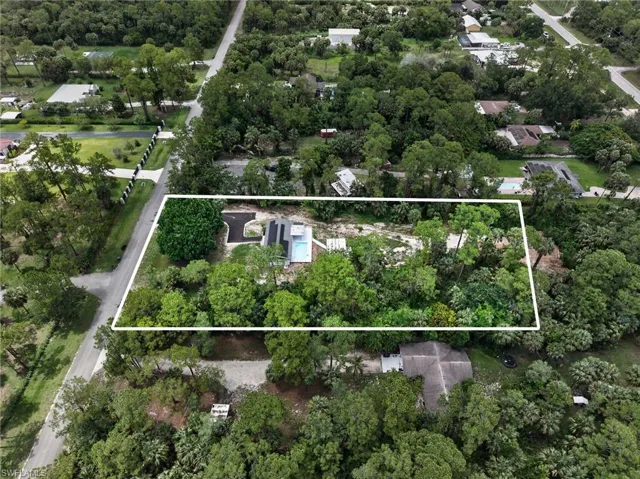 Aerial perspective highlighting a property with a distinct, modern-style residence
