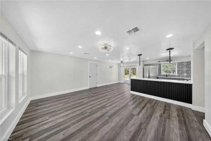 Spacious interior featuring wood-finish flooring, recessed lighting, and a contemporary ceiling fan