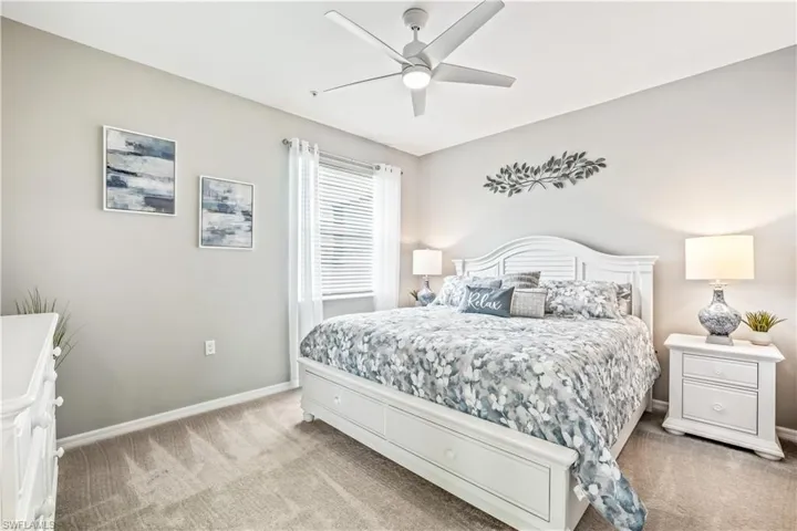 Carpeted bedroom with ceiling fan