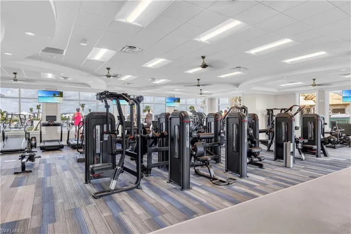 Gym featuring carpet flooring and a paneled ceiling