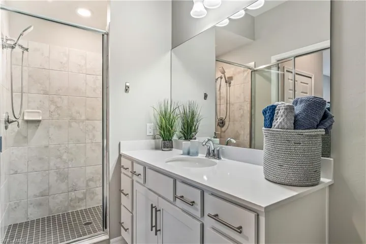 Bathroom featuring vanity and a shower with shower door
