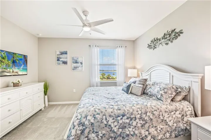 Carpeted bedroom with ceiling fan