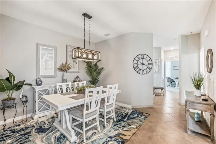 Dining area featuring a notable chandelier and light tile patterned flooring