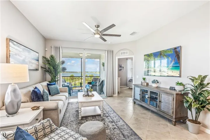 Living room featuring ceiling fan and light tile patterned flooring