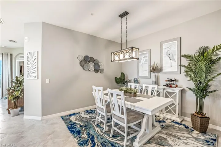 Dining area with a notable chandelier and light tile patterned floors