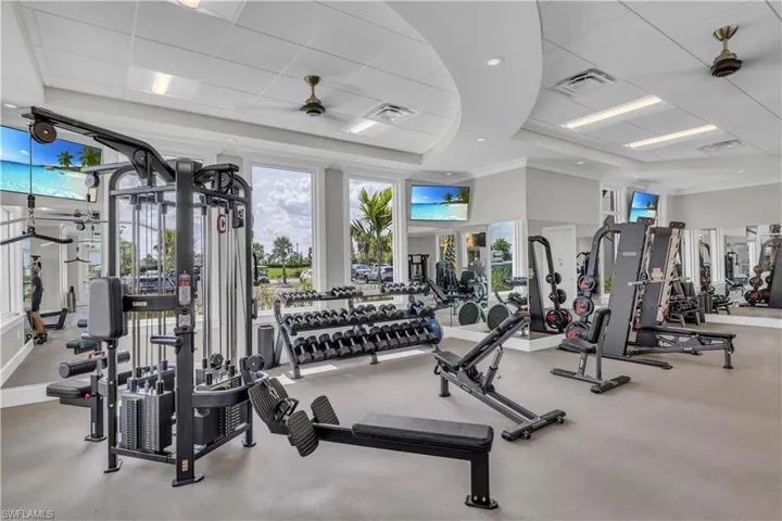 Gym with ornamental molding and a paneled ceiling