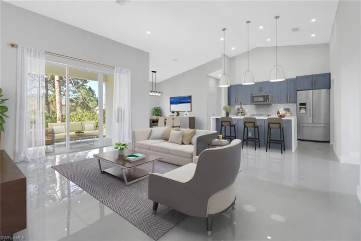 Living room featuring high vaulted ceiling