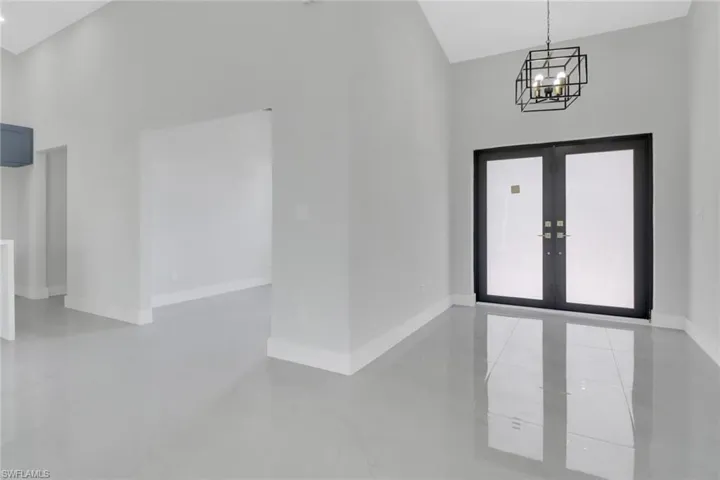 Foyer featuring french doors and a chandelier