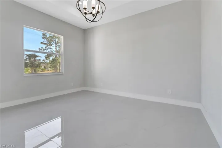 Spare room featuring a notable chandelier