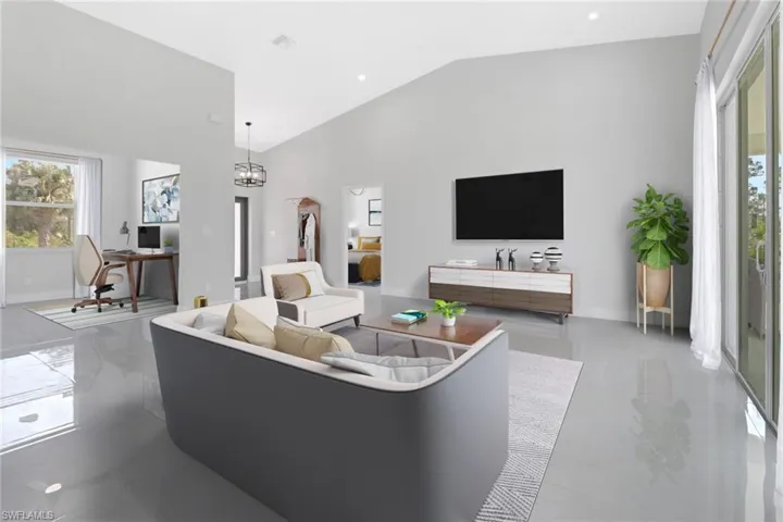 Living room with high vaulted ceiling and an inviting chandelier