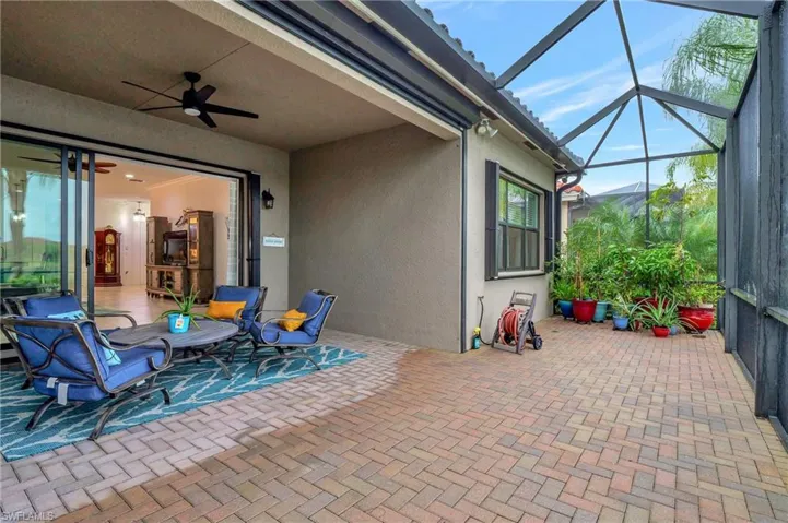 View of patio / terrace with a ceiling fan, a sunroom, and a lanai