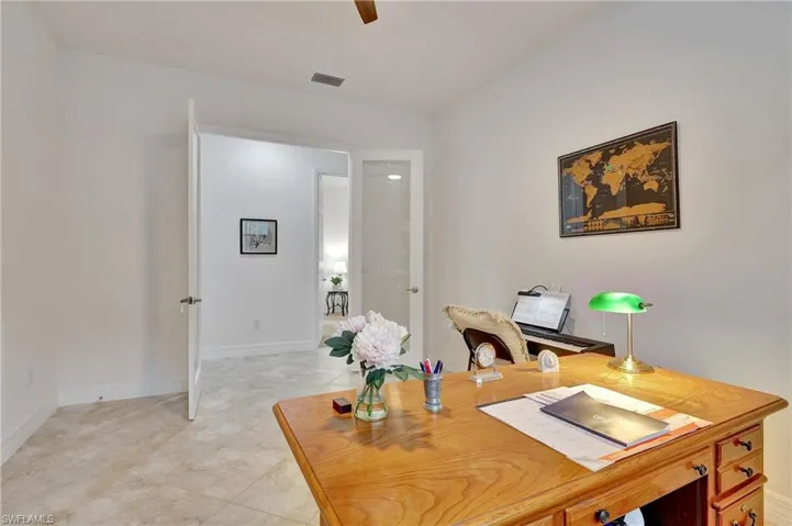 Home office featuring light tile patterned floors and a ceiling fan