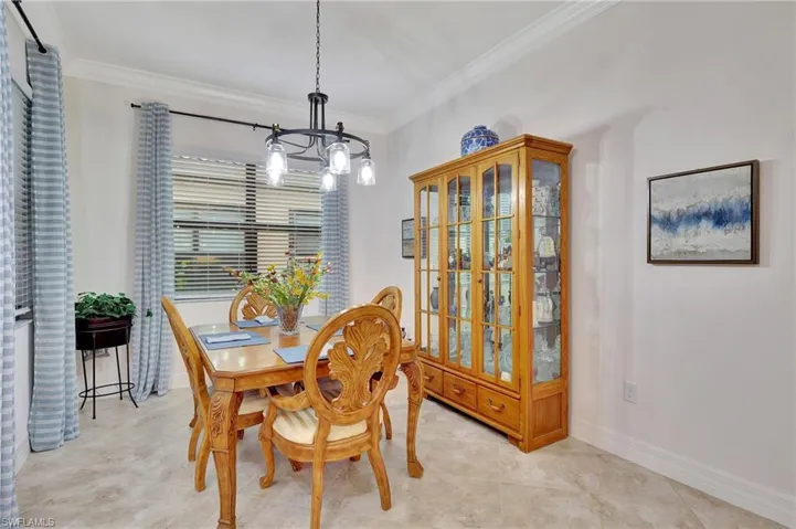 Dining room featuring crown molding and a chandelier