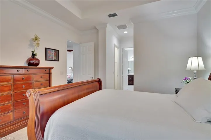 Bedroom featuring ornamental molding, connected bathroom, and recessed lighting