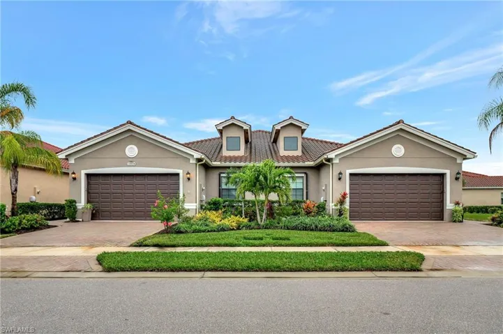 Mediterranean / spanish-style home featuring stucco siding, a tiled roof, decorative driveway, and an attached garage