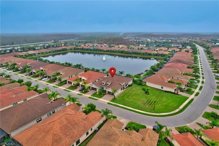 Aerial perspective of suburban area featuring a large body of water