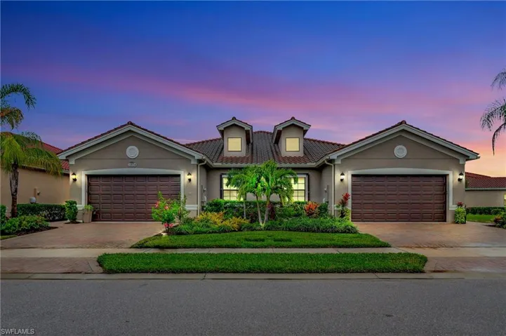 Mediterranean / spanish-style house featuring stucco siding, decorative driveway, a tiled roof, and an attached garage