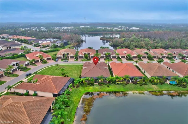 Aerial perspective of suburban area featuring a nearby body of water