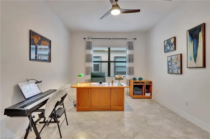 Office featuring a ceiling fan and baseboards